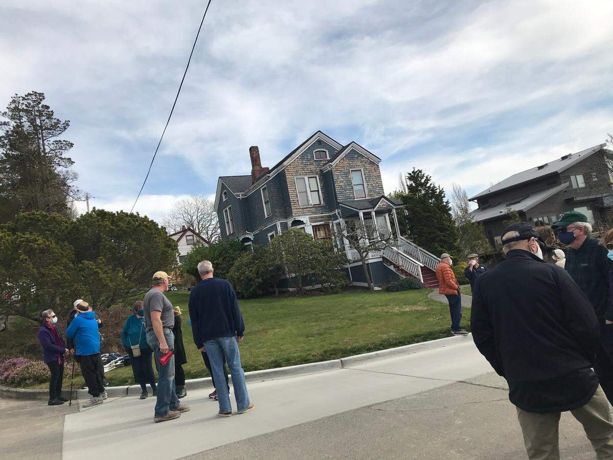 Neighbors in Bellingham Mayor Seth Fleetwood’s South Hill neighborhood gather Saturday, March 13, as protesters planned to march to the home.
