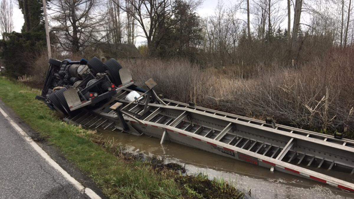 A Tuesday morning rollover at Hovander and West Smith roads near Ferndale spilled up to 100 gallons of diesel into a water-filled ditch next to wetlands.