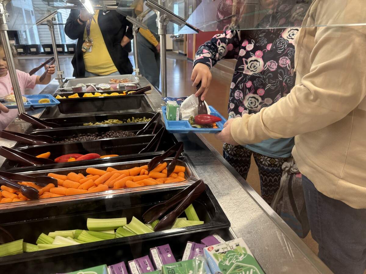 Children help themselves to the salad bar at Parkview Elementary School on June 30, 2026, in Bellingham, Wash. The Bellingham School District is one of several organizations in Whatcom County offering free summer lunches to all kids under 18, even if they attend a different school district.