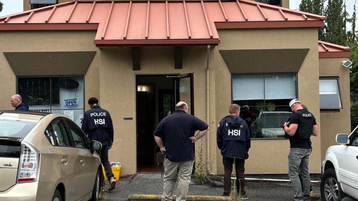 Homeland Security officers stood outside 33 Mansion Mental Massage Spa at 1333 Lincoln Street on August 13, 2024, after two human trafficking victims were rescued from the business during a search conducted by the Whatcom Gang and Drug Task Force in Bellingham, Wash.