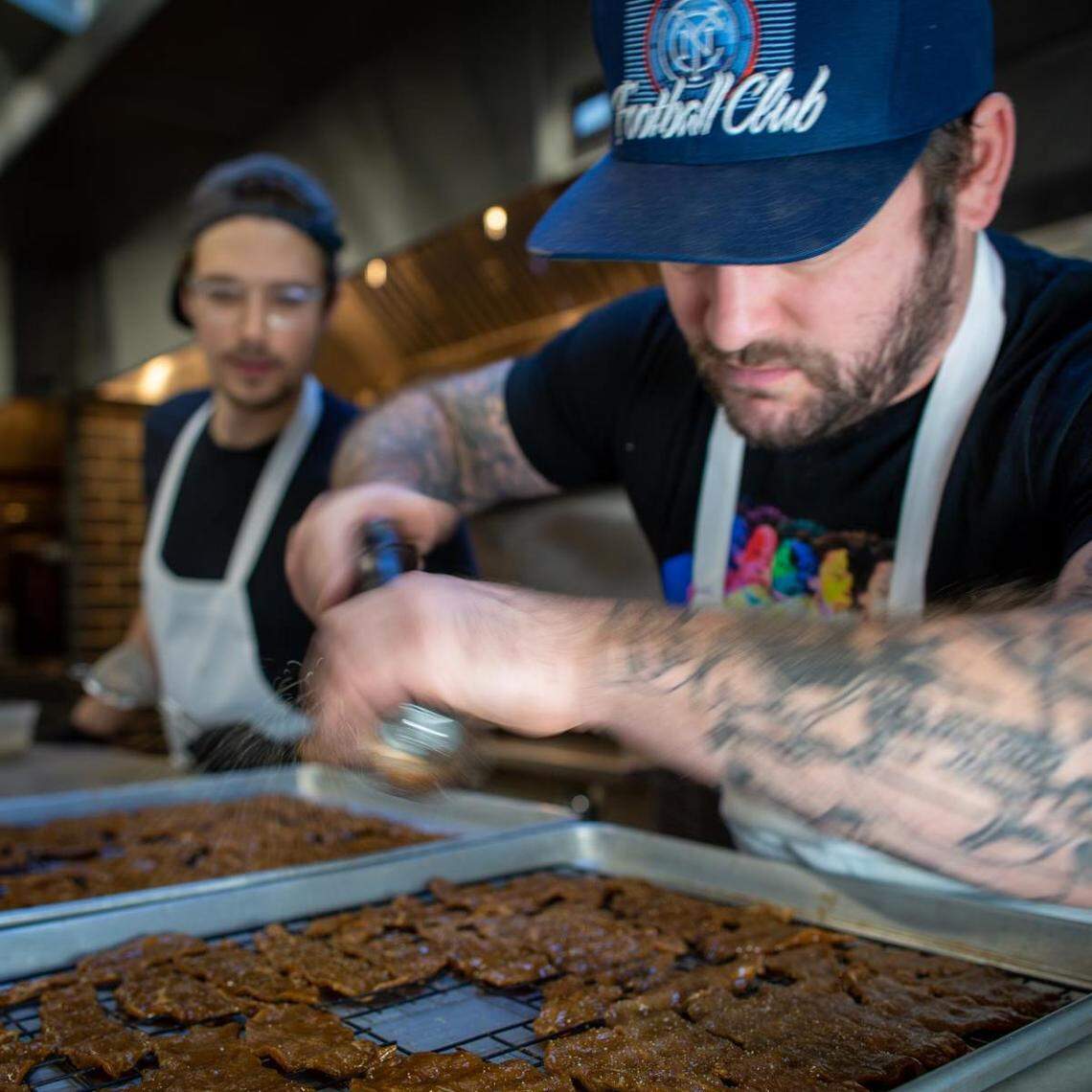 Carnal business partners and executive chefs James Zamory and Sean McDermott prepare jerky. The Bellingham company has seen strong sales of the product.