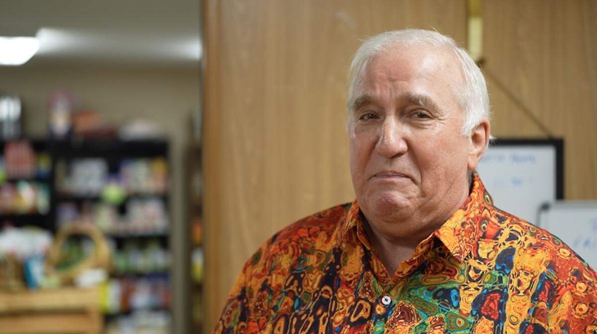 Dan Quint stands in front of the food pantry at the Woodrose Senior Affordable Apartments. He and his wife, Debra, started the food pantry with the help of their local church to feed their food-insecure neighbors in Bellingham.