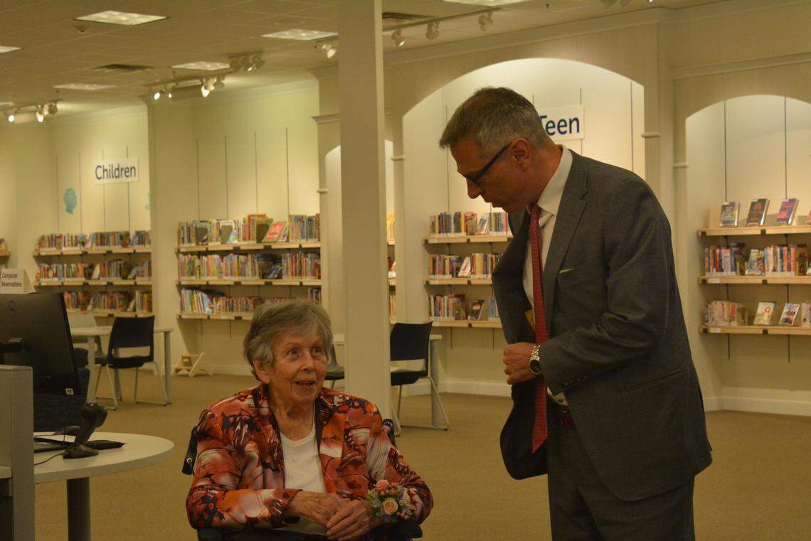 Cordata neighborhood advocate Julianna Guy, left, chats with Bellingham Mayor Seth Fleetwood as the Bellingham Public Library opened its new branch at Bellis Fair mall on Wednesday, April 26.