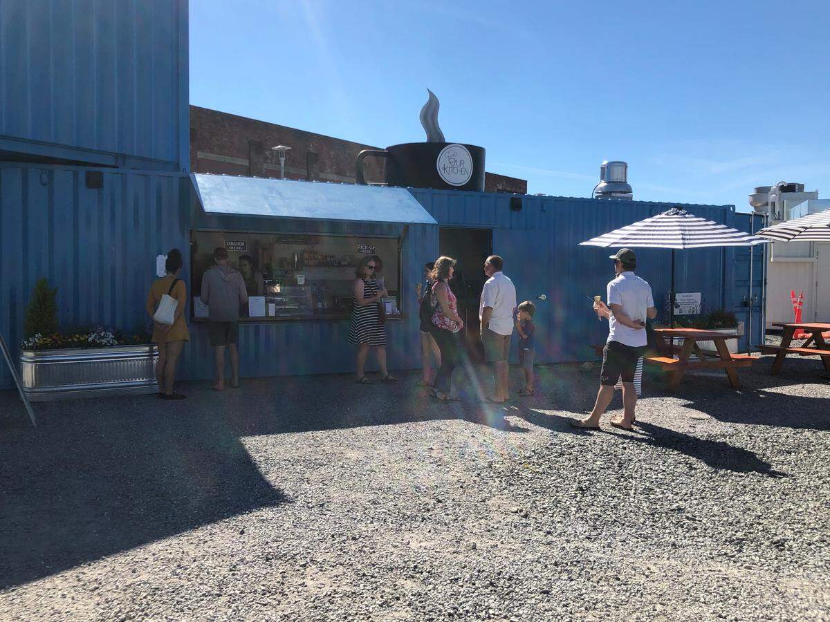 People stop for coffee Sunday, June 26, at The Portal Container Village & Market on the waterfront near downtown Bellingham.