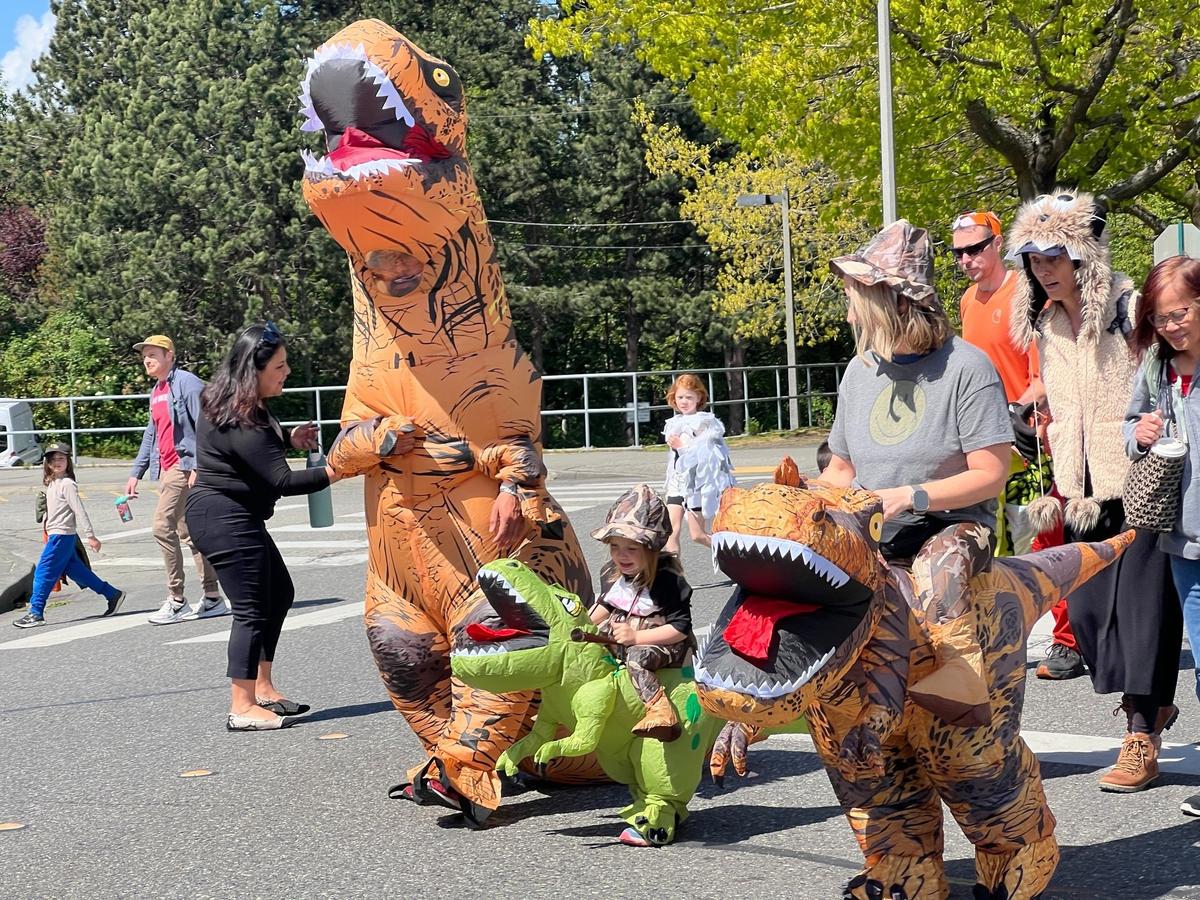 Family members dressed as a pack of velociraptors is shown at the start of the 2025 Procession of the Species parade on Grand Avenue in downtown Bellingham, Wash. 