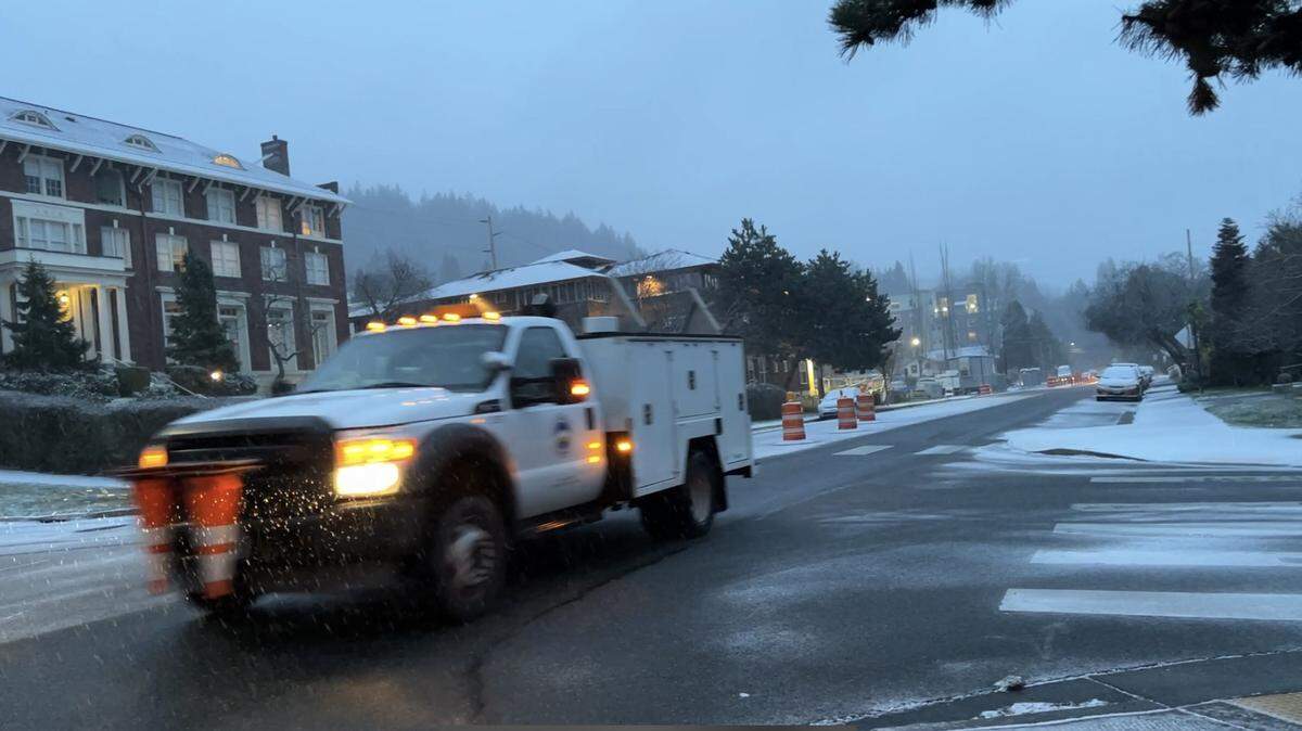 A city of Bellingham worker drives on North Forest Street near East Maple Street as light snow falls early Tuesday, Jan. 31, in downtown Bellingham.