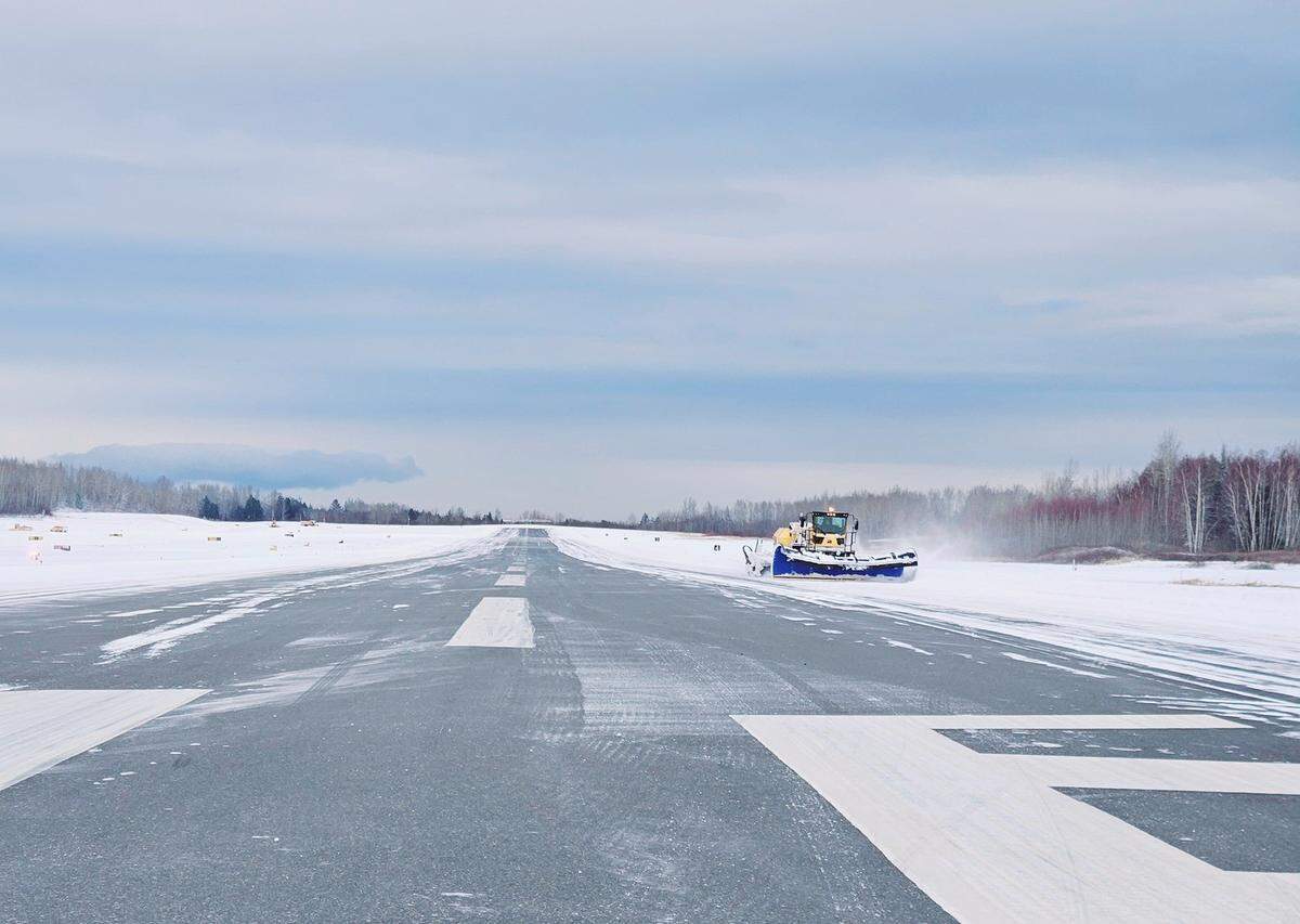 Snow is plowed off the runway at Bellingham International Airport on Thursday.