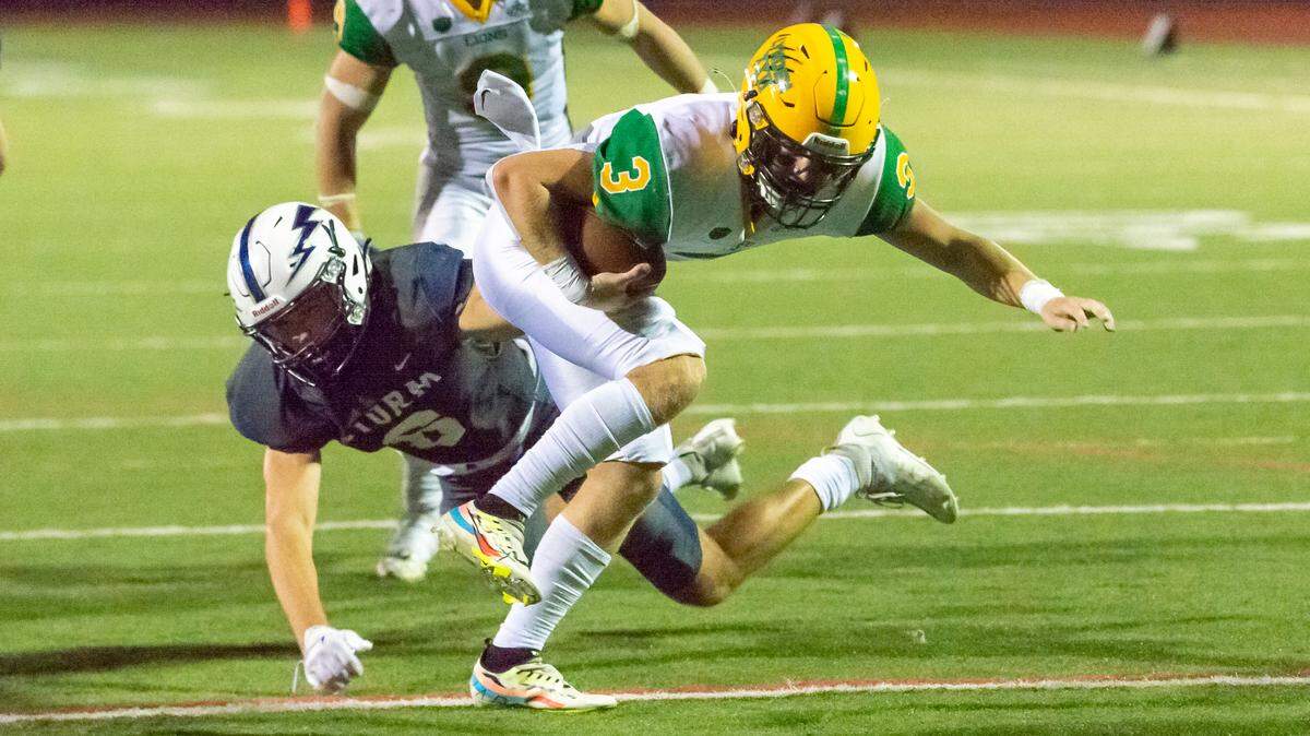 Lynden quarterback Kaedan Hermanutz (3) evades Squalicum linebacker Marcus Nixon (8) at the goal line to score a touchdown late in the second quarter on Friday evening Sept. 16, at Civic Stadium in Bellingham.