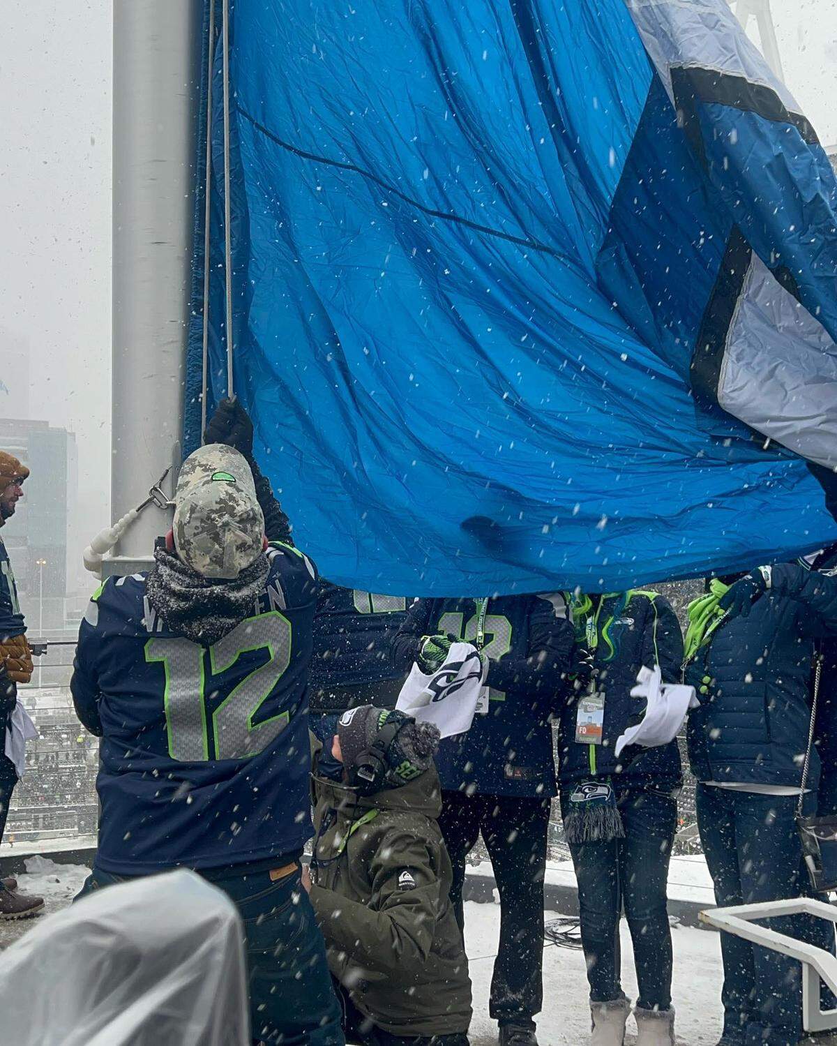 Lynden high school football coach Blake Van Dalen raises the 12th Man flag Sunday at Seattle’s Lumen Field before the Seahawks’ game against the Chicago Bears Sunday, Dec. 26.