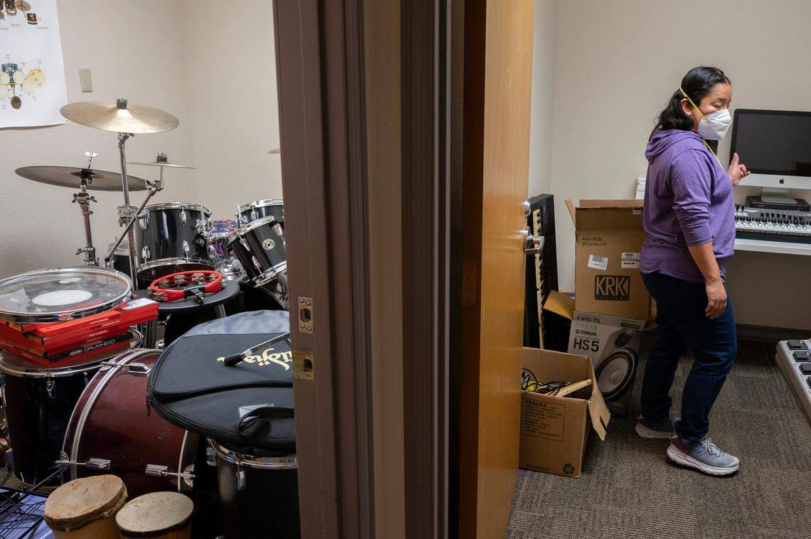 Musical instruments are stored in one room while Gaby Salazar sets up new recording equipment in another at the Northwest Indian College on Tuesday, April 5, in Whatcom County.