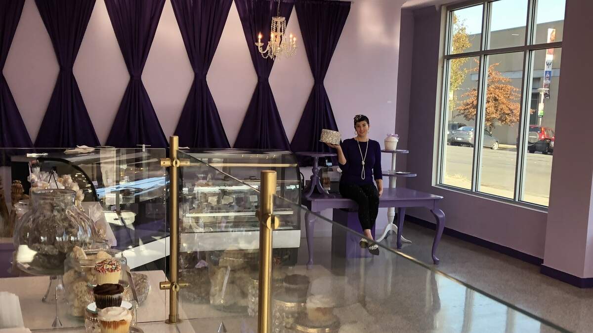 Vie Sweet, owner of Icing on the Cake, holds a cake in her new space on Grand Avenue in Bellingham. The new space is twice as big as the bakery’s previous location.