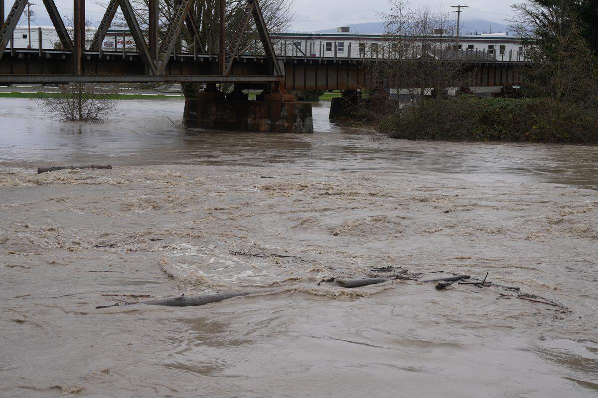 The Nooksack River was flowing fast and high on December 10, 2025, through Ferndale, Wash., as the city issued a voluntary evacuation order amid rising waters and flooding.