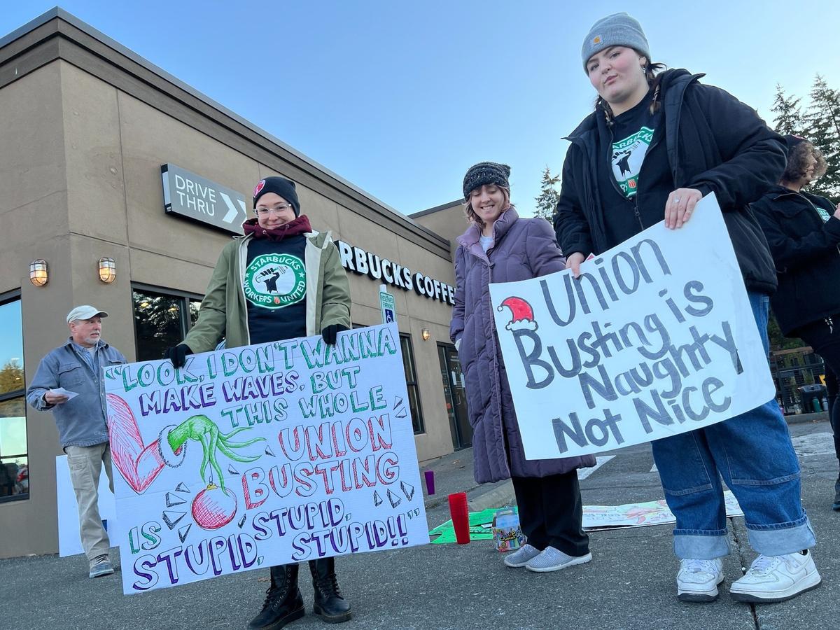 Starbucks workers Sophia Hart, left, and Gill Simpson picket outside the specialty coffee chain’s location in the Sehome Village shopping center in Bellingham, Wash., on Thursday, Nov. 17, 2022.