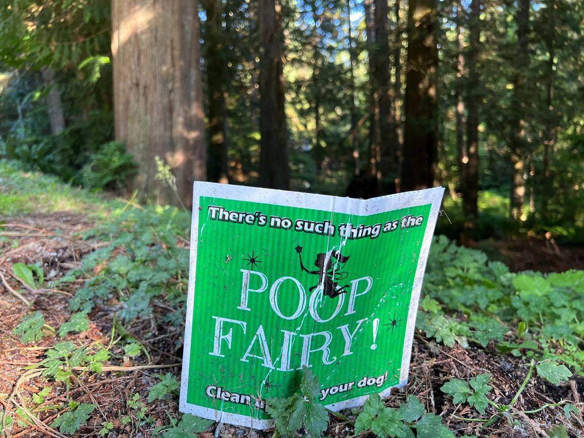 A sign on Lost Lake Lane in the rural enclave of Sudden Valley east of Bellingham, Wash., encourages dog owners to take their pet waste with them on Sunday, June 11, 2023.
