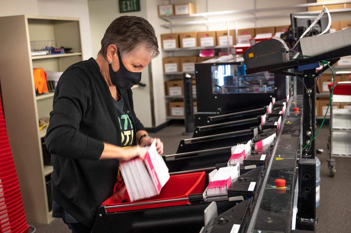 Whatcom County Auditor Diana Bradrick sorts general election ballots at the Whatcom County Courthouse on election day Tuesday, Nov. 2, in Bellingham. Results are due after 8 p.m.