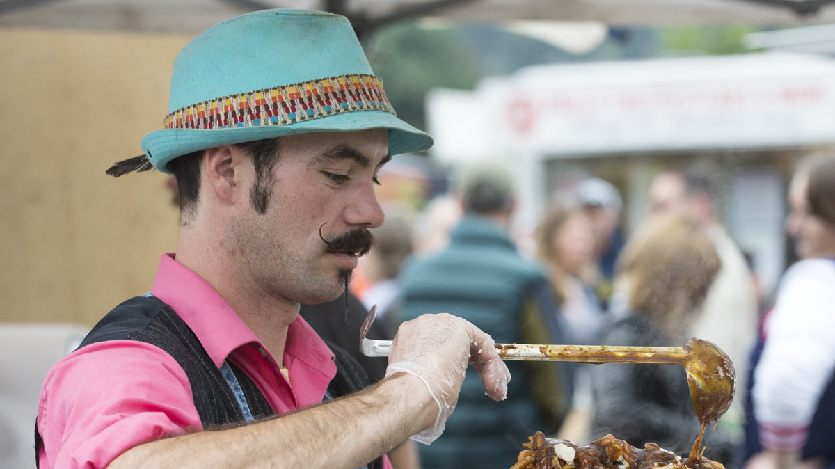 Kurlys owner River Mitchelle ladles chili onto fresh-cooked french fries at the Food Truck Round Up at Civic Stadium on Saturday, Sept. 27, 2014 in Bellingham, Wash. Kurlys was one of 13 vendors to attend the event.