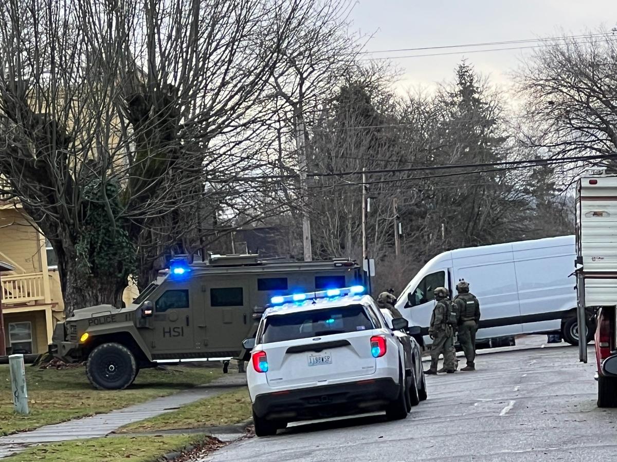 Homeland Security Investigations officers wait outside a house near York and Iron streets in Bellingham around 9 a.m. Wednesday, Nov. 30. An officer told The Bellingham Herald that they were arresting people on outstanding warrants.
