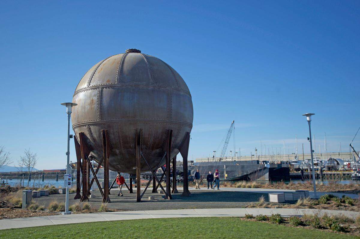 People walk near the “Acid Ball” at Waypoint Park in February 2020. A trail connection, restrooms and outdoor games are proposed for the second phase of development of the park on Bellingham’s downtown waterfront.