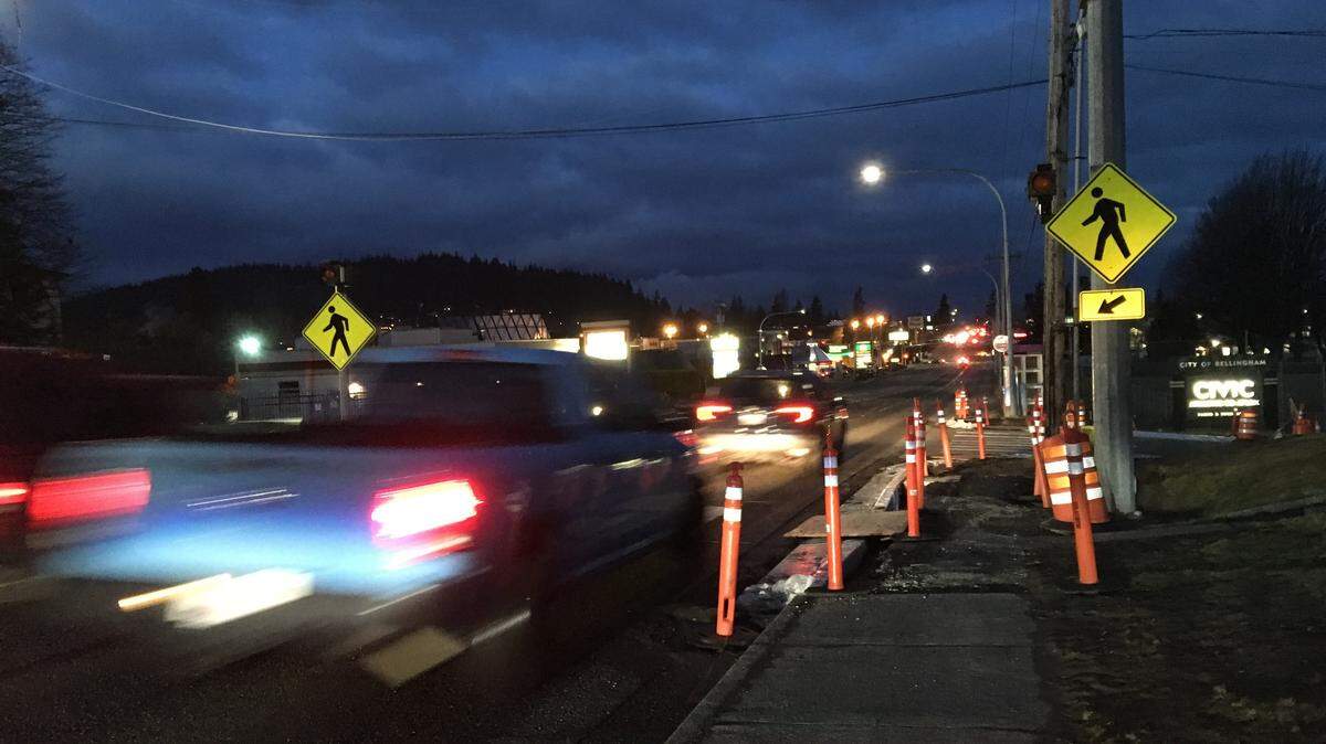 Morning commuters drive past a pedestrian crossing on Lakeway Drive near Orleans Street in Bellingham in 2019. While it’s a good idea for people walking near roadways to wear bright clothes and carry lights, motorists also must do their part to avoid traffic fatalities.