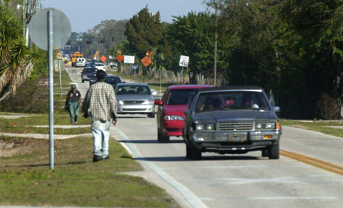 Walking along a road without a sidewalk with your back toward traffic in Washington state is illegal and a bad idea for safety sake. Darkness, impairment and speed also impact pedestrian deaths.