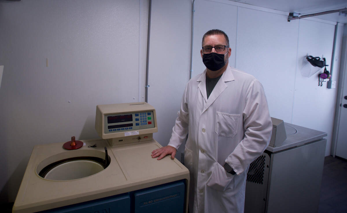 Kent Oostra stands next to an ultracentrifuge at his laboratory, Exact Scientific Services, on Friday, Oct. 30, in Ferndale.