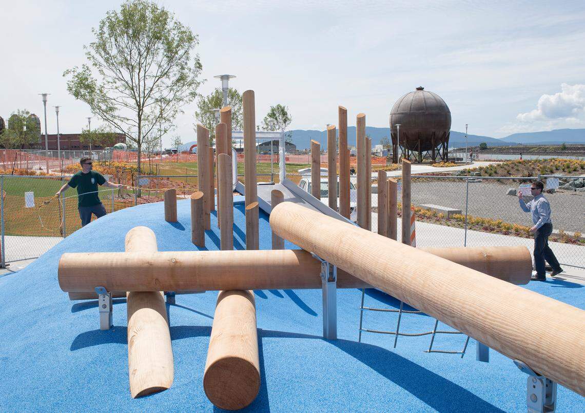 Bellingham Parks and Recreation employees Russ Isaly, right, and Josh Neyman measure the square footage of the playground surface at Waypoint Park in Bellingham.
