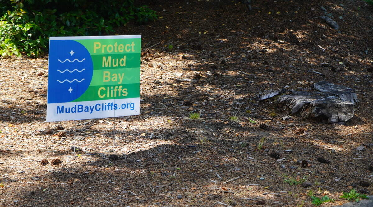 A ‘Protect Mud Bay Cliffs’ sign is posted in the front yard of an Edgemoor resident on July 6, 2023, in Bellingham, Wash.
