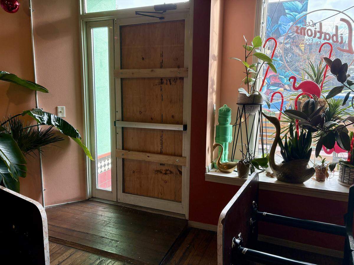 The door to L&L Libations in Bellingham is boarded up following a break-in on Dec. 2, 2025.