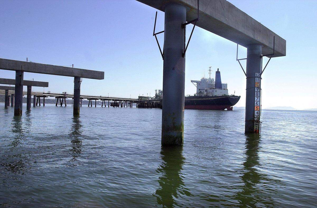 The oil tanker Overseas Chicago is framed by a pier under construction in 2000 at Cherry Point in Whatcom County. The U.S. Army Corps of Engineers released the final environmental impact statement about the dock this month, almost 20 years after environmental groups sued over its construction.