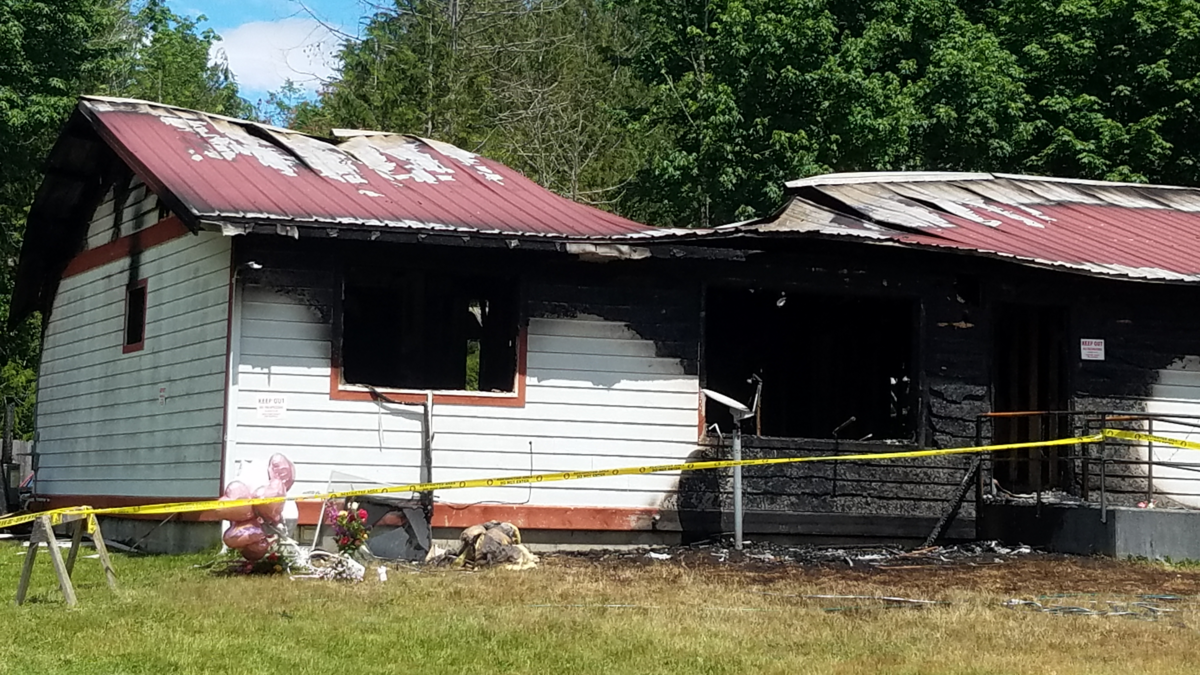 Angelita E. Aure’s Deming home caught fire Wednesday in Whatcom County. Aure died in the fire from smoke inhalation. A small memorial with balloons and flowers had been placed out front of her home Thursday.