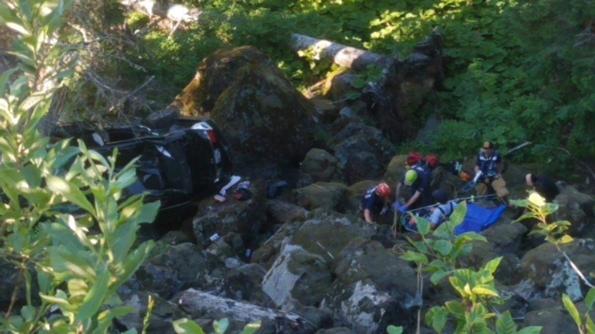 Whatcom County Fire crews from districts 19 and 14 rescue two occupants of a Honda Civic that left the Mount Baker Highway near milepost 51 and fell nearly 150 feet on Saturday. Neither occupant suffered any serious injuries.