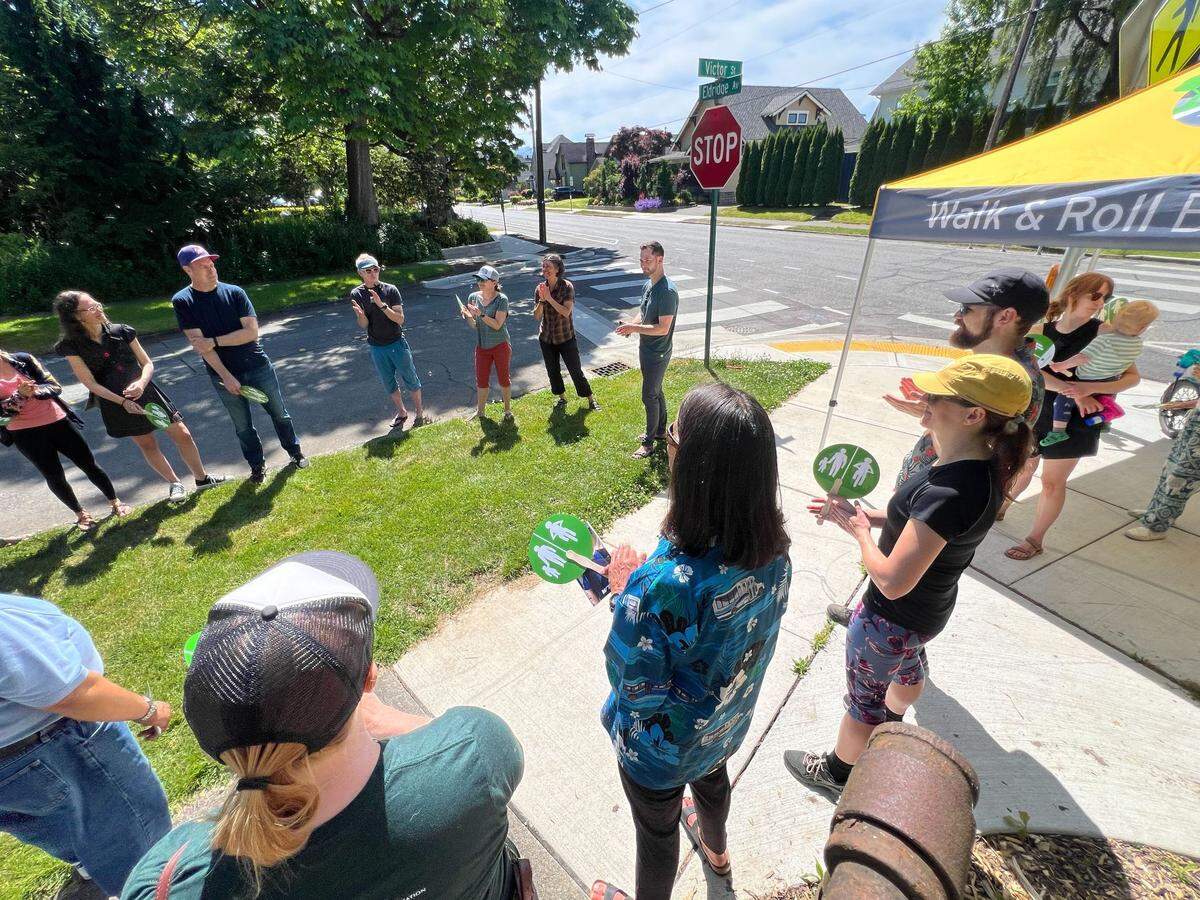 Columbia neighborhood residents, members of Walk and Roll Bellingham and officials with the city of Bellingham and Whatcom Transportation Authority attend a ribbon-cutting for crosswalks and bike lanes Saturday at Carl Lobe Park on Eldridge Avenue in Bellingham.