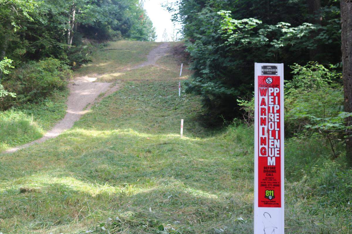 A sign shows where an underground pipeline sits in Whatcom Falls Park. The park saw a deadly pipeline explosion that rocked the community in June 1999.