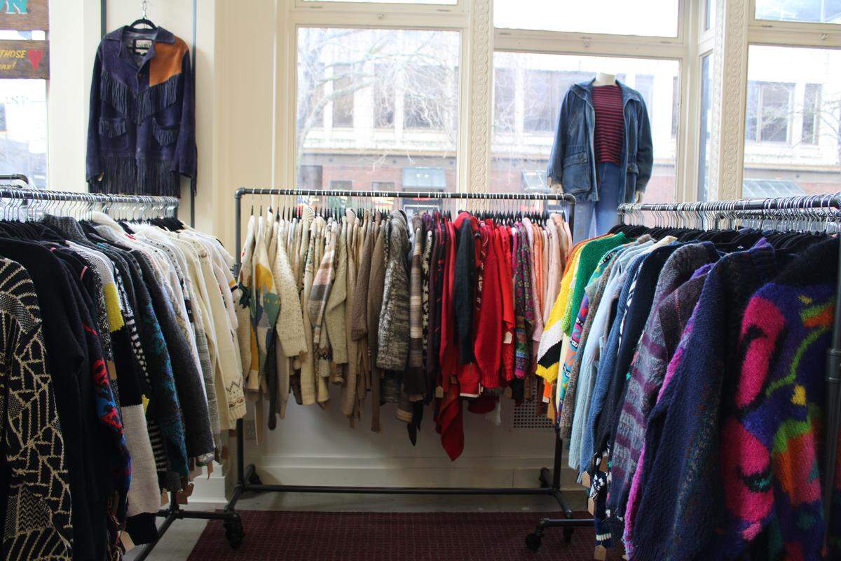 Racks of clothing at Worn AgainThrift in Bellingham are organized by color, not size.
