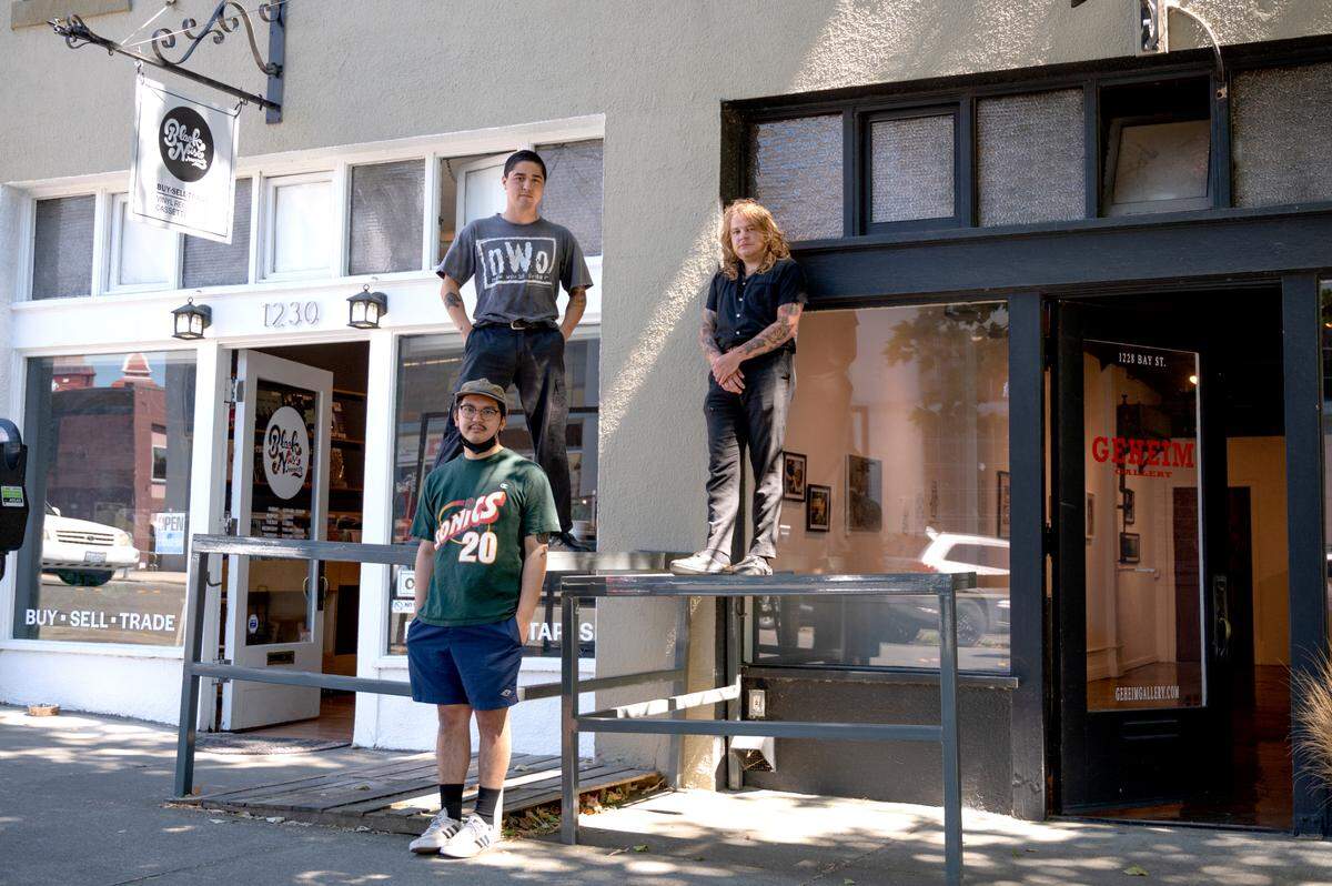 Niko Sanchez, left, owner of Black Noise Records, and Desi Valdez and Jackson O’Rourke, co-owners of Geheim Gallery, gather on Bay Street on Thursday, June 24, in Bellingham. They are hoping to add to the art scene downtown.