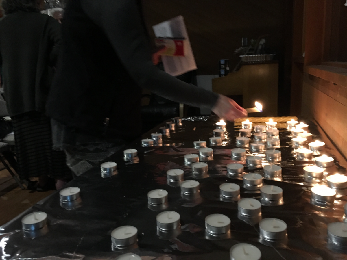 Participants light candles of mourning after the service at the Rohr Center for Jewish Life in Bellingham Monday evening. At the service for the victims of the Pittsburgh synagogue shooting, speaker Nissa Yarmush said “Fight darkness with light, untruth with truth, death with life.”