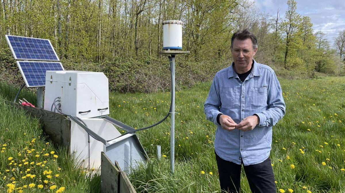 Dr. Bill Wavrin stands by a water quality monitoring station on his dairy farm, Western Waves, in Ferndale.