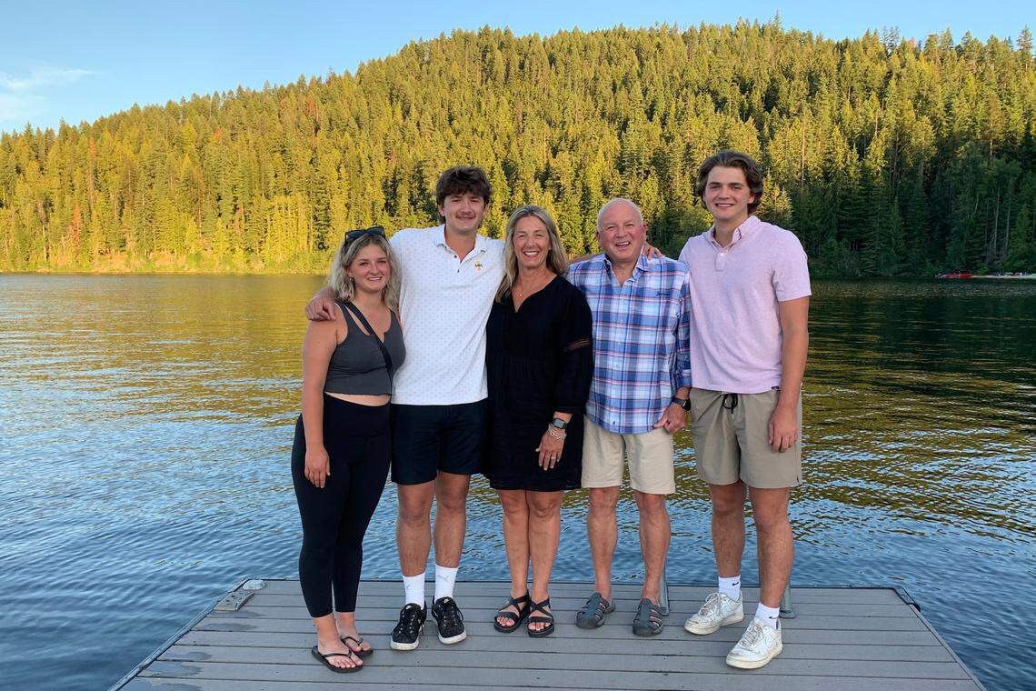 In this photo provided by Stacy Chapin, triplets Maizie, left, Ethan, second from left, and Hunter, right, pose with their parents Stacy and Jim Chapin at Priest Lake in northern Idaho in July. Ethan Chapin was one of four University of Idaho students found stabbed to death in a home near the Moscow, Idaho, campus on Sunday, Nov. 13. Police are still searching for a suspect in the case.