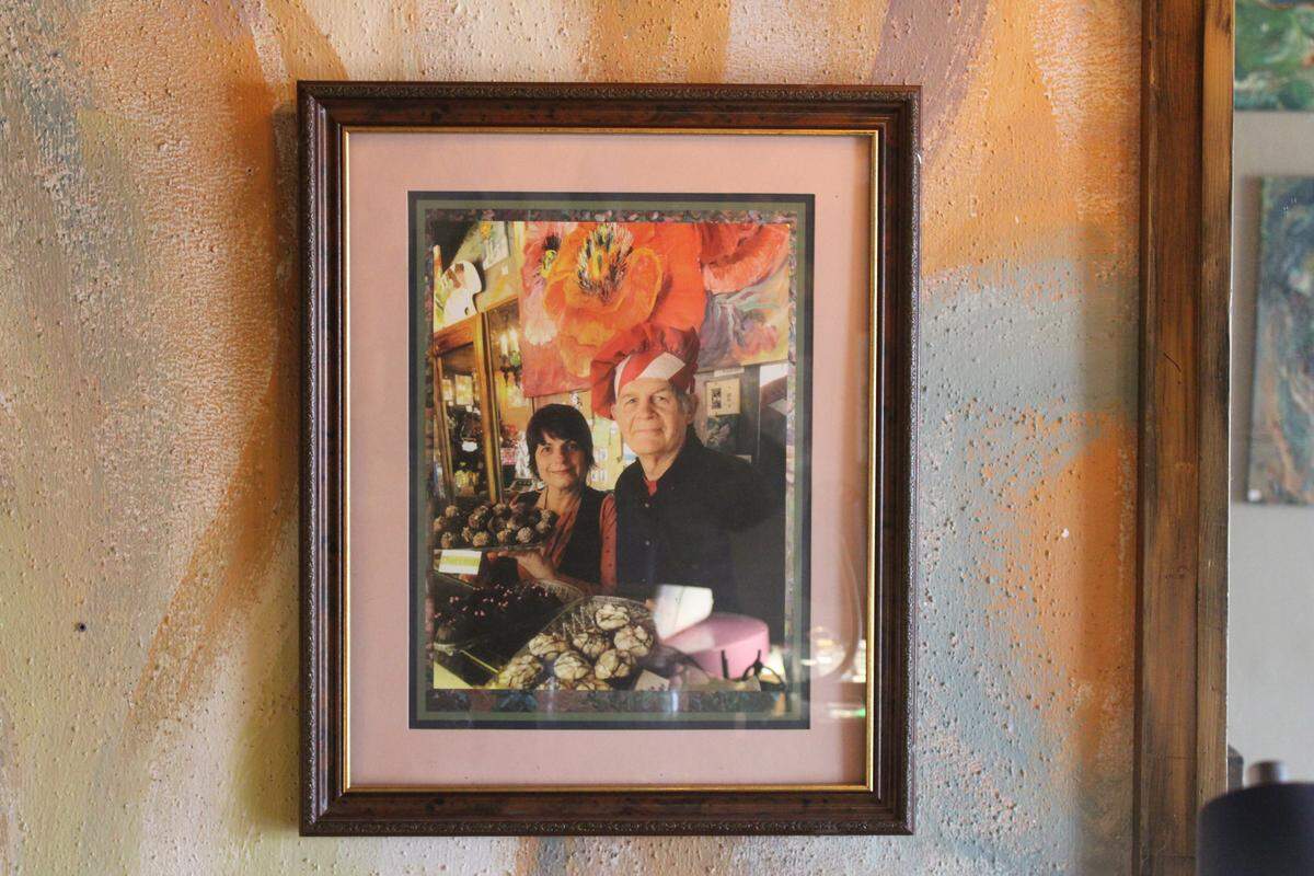 A photo of Vivian and Jerry Hruska, former owners of Sweet Art, hangs on the wall of the Bellingham chocolate shop.