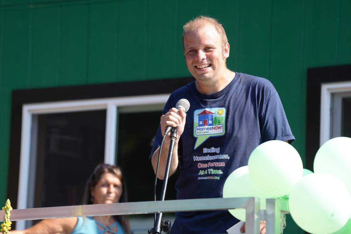 HomesNOW! Not Later Board of Directors Chairman Doug Gustafson speaks at the grand opening celebration.