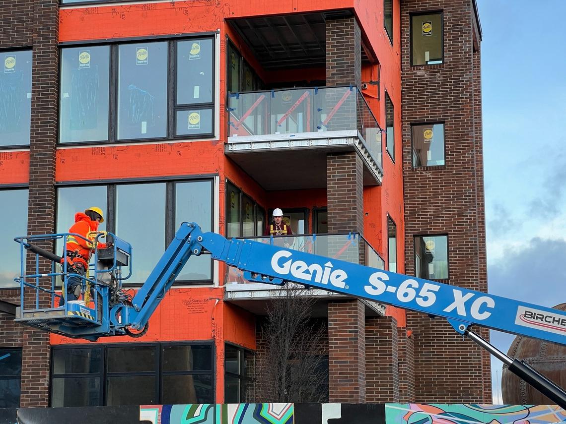 Construction workers are shown at job site for Harcourt Developments, which is building multimillion-dollar condos on Granary Avenue near the waterfront in Bellingham, Wash., on Wednesday, March 13, 2024.