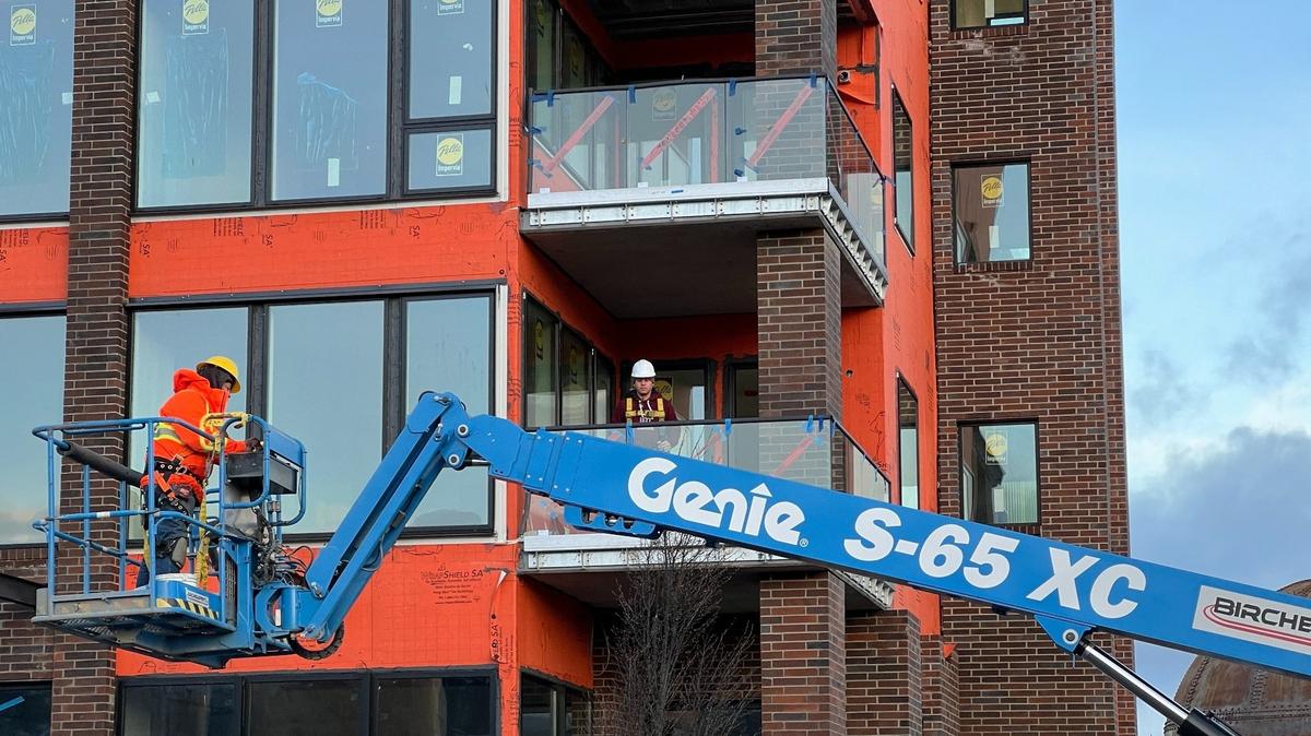 Construction workers are shown Wednesday at a job site for Harcourt Developments, which is building multimillion-dollar condos on Granary Avenue near the Bellingham waterfront.