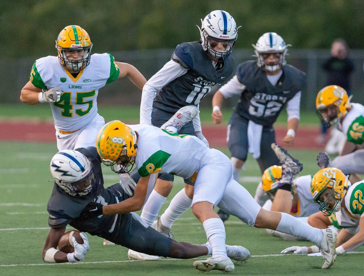Lynden defensive back Isaiah Stanley (8) stops Squalicum running back Marcus Nixon (8) at the line of scrimmage during the first quarter on Friday evening Sept. 16, at Civic Stadium in Bellingham.