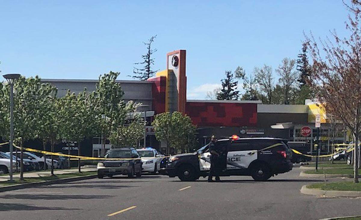 Bellingham police officers marked the area surrounding the Regal Cinemas movie theater in Bellingham with crime scene tape and move people away from the area following a bomb threat at the theater on Sunday, April 28.