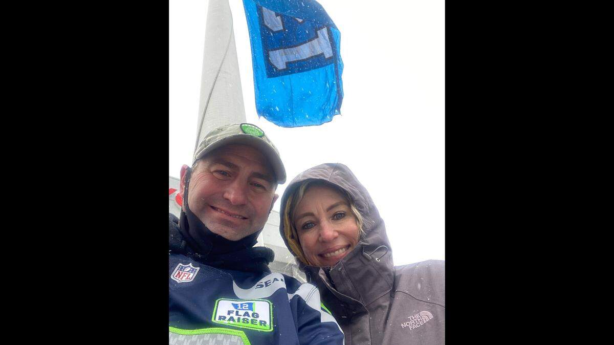 After Lynden high school football coach Blake Van Dalen raised the 12th Man flag Sunday at Seattle’s Lumen Field before the Seahawks’ game against the Chicago Bears, Sunday, Dec. 26, he and his wife, Melissa Van Dalen, took a picture of themselves with the flag.