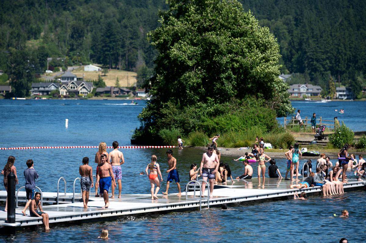 People play at Bloedel Donovan Park on Lake Whatcom on Monday, June 21, in Bellingham. Lifeguards will be reinstated from Saturday, June 26, through Aug. 31 from noon to 7 p.m. daily.