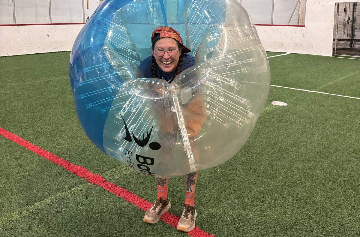 Beaux Loftis smiles from inside a bubble while playing bubble ball. Loftis is usually the Zamboni driver at Sportsplex.