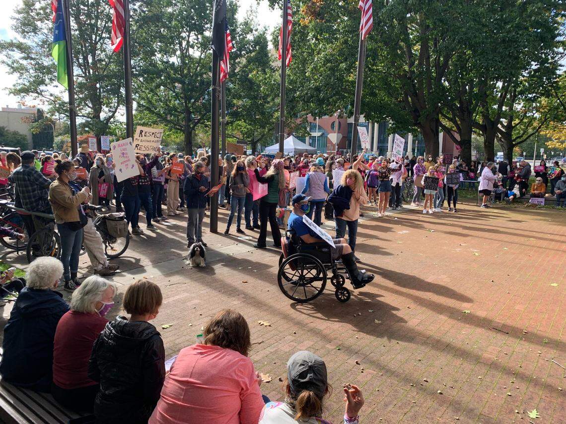 Women’s-rights activists gather outside Bellingham City Hall Saturday afternoon, Oct. 2, for a planned rally and march to show support for abortion access nationwide.