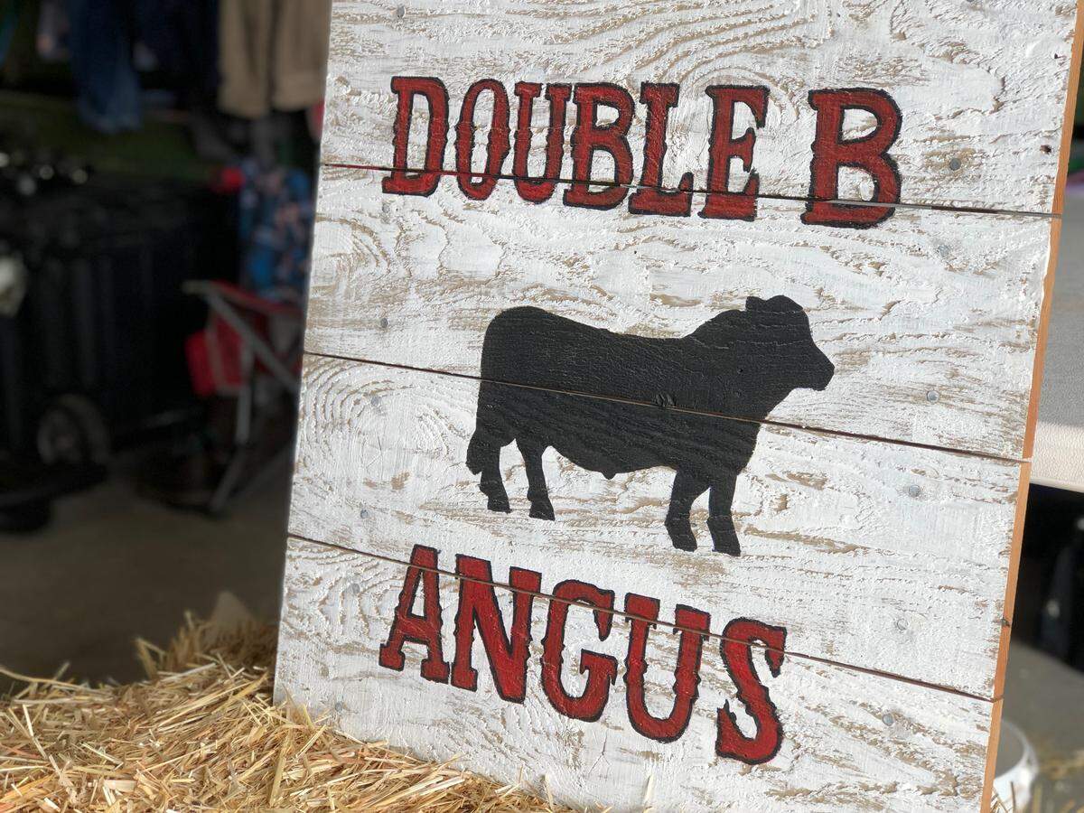 A “Double B Angus” sign notes where the Brinks’ cows are located inside the beef barn at the Northwest Washington Fair in Lynden, Wash., Tuesday, Aug. 13, 2019. Their area includes the animal’s stalls, a tack area and a place for the family to sit.