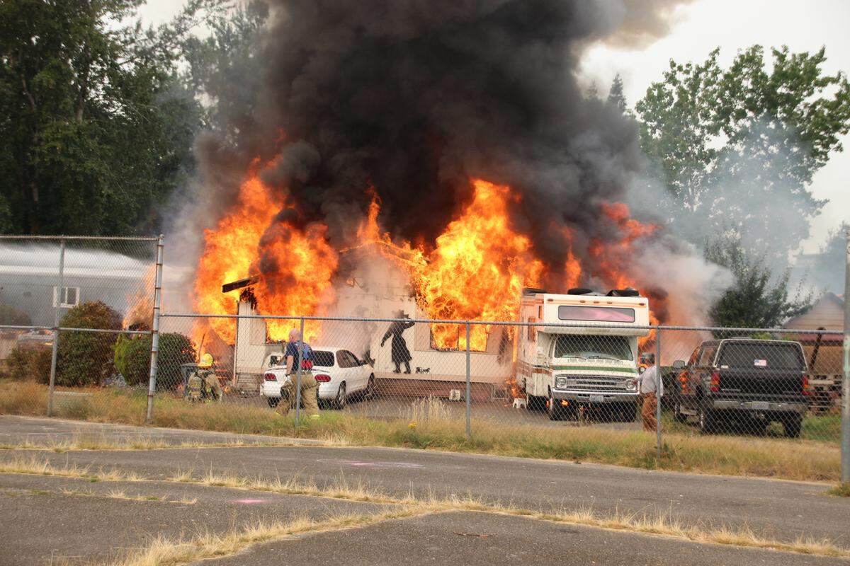 A mobile home near Bellis Fair Mall was destroyed by fire Sunday morning and a resident suffered burns to his arms and head in Bellingham. Two other units were damaged by the blaze.